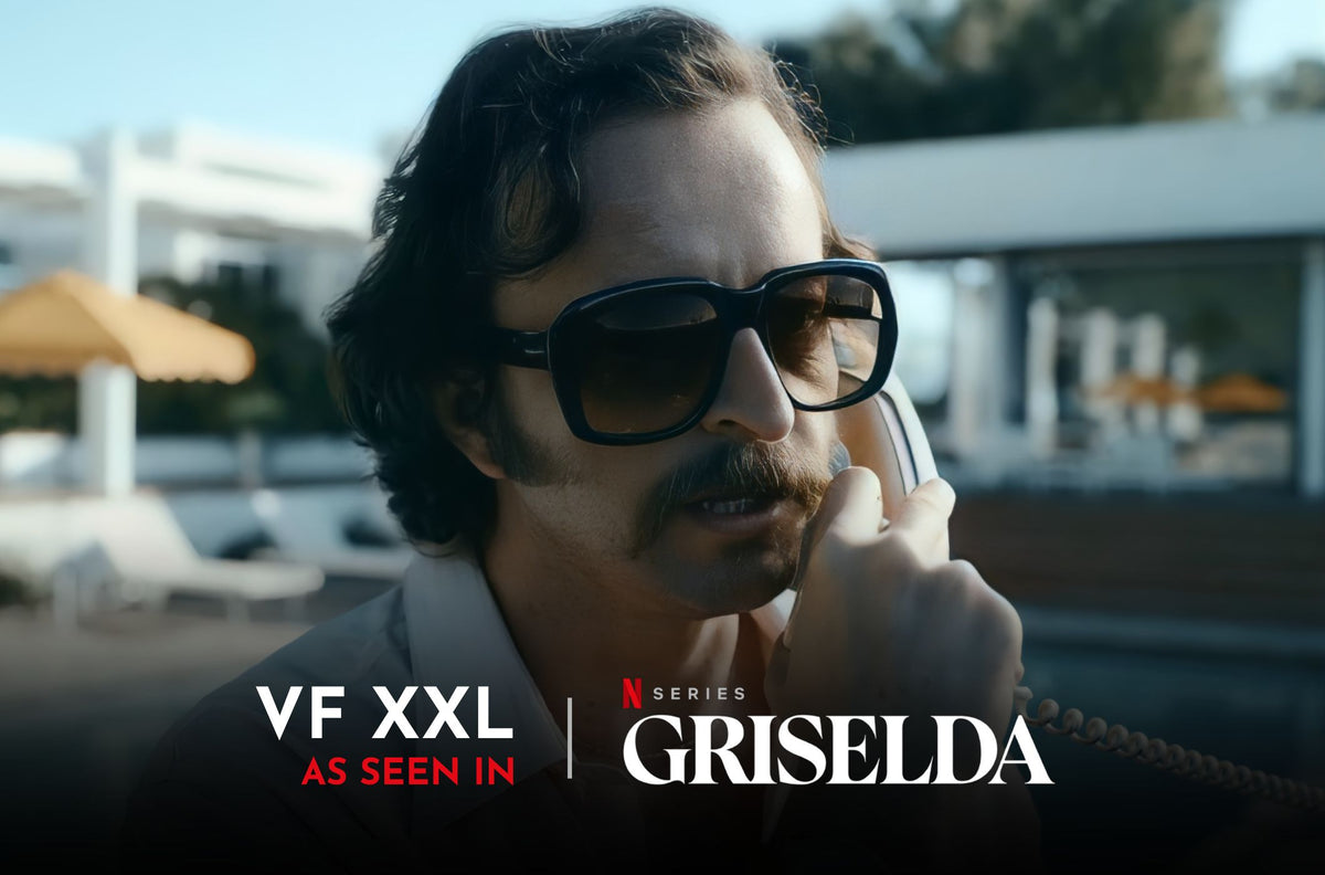 Griselda male actor wearing sunglasses on the phone